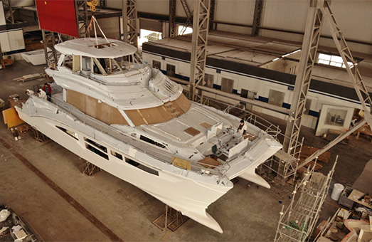 An Aquila power catamaran being constructed in a factory