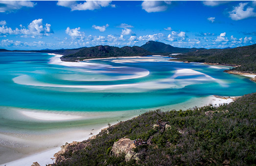 An aerial shot of the blue water in an inlet in the Whitsunday Islands