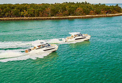 Aquila 32 and 36 sport power catamaran boats cruising side by side