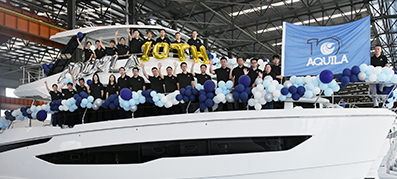 Aquila team in front of an Aquila Boat