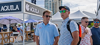Customer and team member at the booth at the Fort Lauderdale International Boat Show