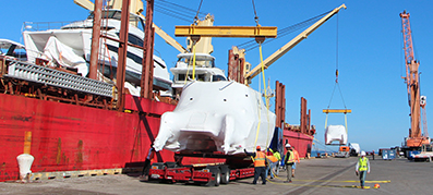 Wrapped Aquila Power Catamaran being unloaded from the ship in Port Manatee