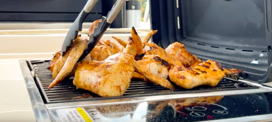 Chicken wings on a grill on Aquila Power Catamaran