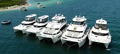 five Aquila Power Catamarans anchored in a row