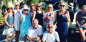 Group smiling celebrating becoming owners of Aquila boat