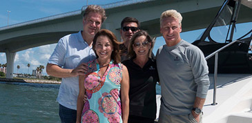 Aquila owners Bruce and Cydne Cooley celebrating aboard their boat with friends