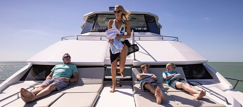 family on hanging out on the bow of boat