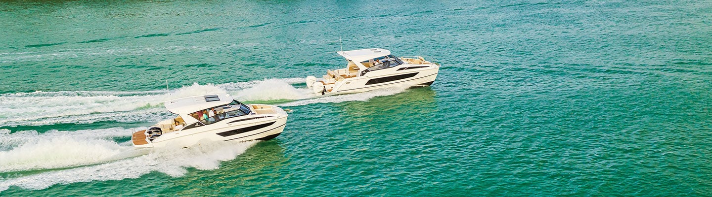 Aquila 32 and 36 sport power catamaran boats cruising side by side