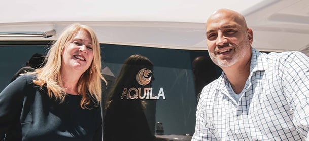 Aquila owners in front of their yacht